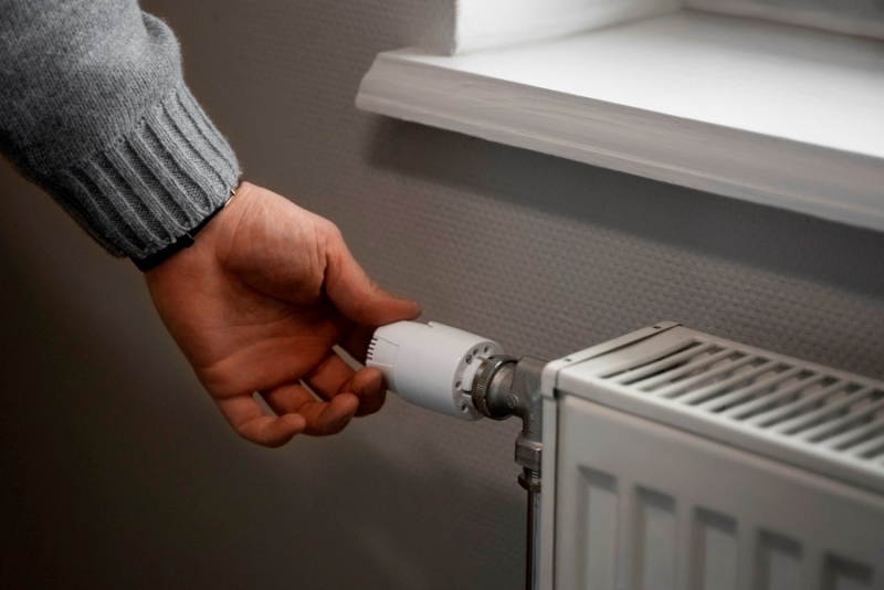 man-turning-off-radiator-energy-.jpg